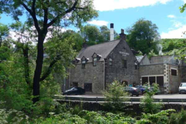The Dufftown Distillery buildings among trees, home of The Singleton of Dufftown