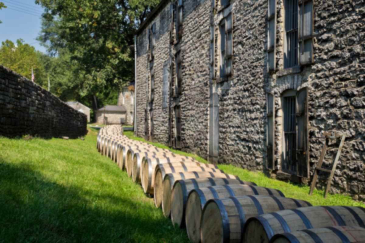 Barrels beside a stone warehouse at Woodford Reserve, maker of a Kentucky rye whiskey