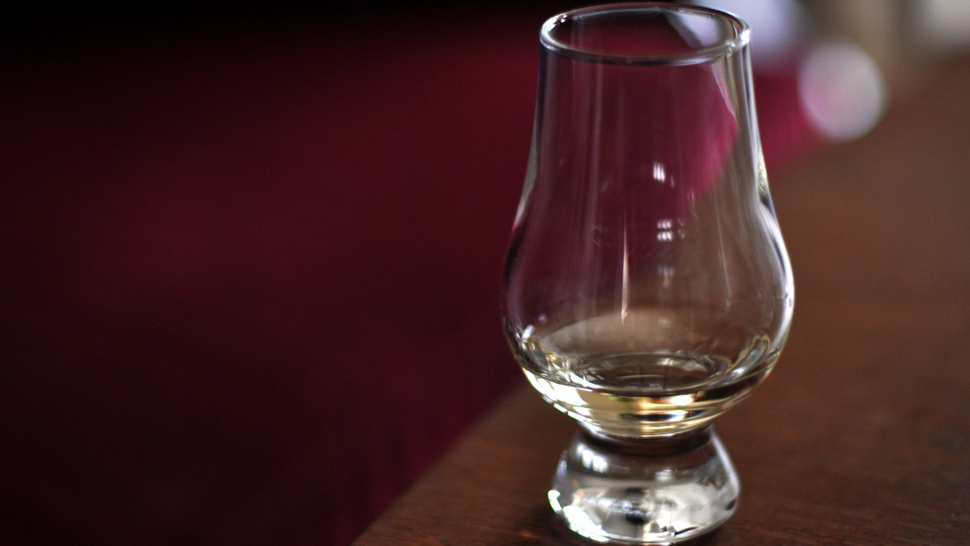 Glass of whisky in warm amber light, the opening image of the Whisky Malaysia guide