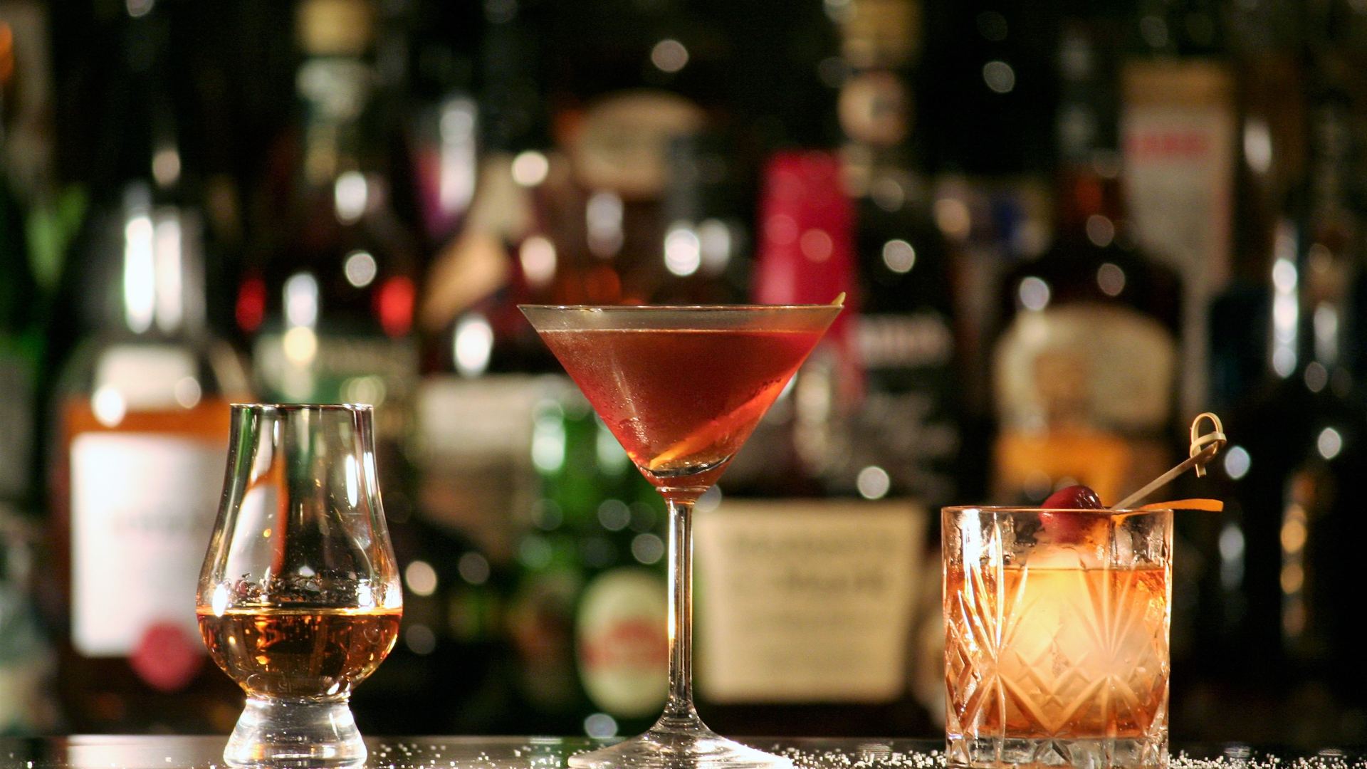 A row of whisky glasses on a bar counter, shown in our whisky glasses Malaysia guide