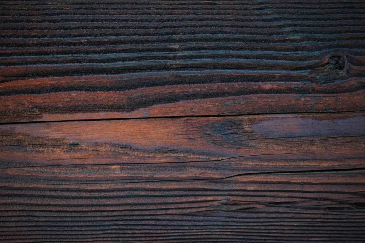 Dark oak wood texture used as the background for the image credits page